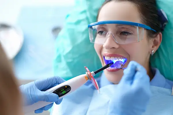 Woman receiving dental bonding treatment at Avery Dental Center 