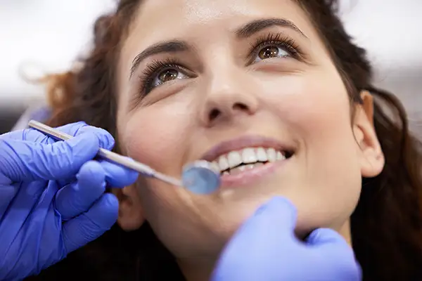 Woman receiving dental cleaning at Avery Dental Center 