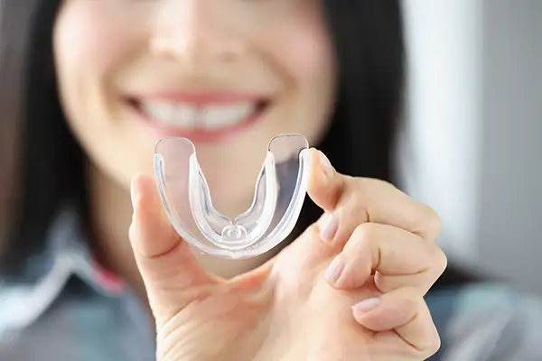 Woman receiving a mouth guard to prevent grinding at Avery Dental Center 